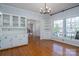 Spacious dining room featuring hardwood floors, built-in shelves, and a view of the front yard at 107 Doris Ct, Lincolnton, NC 28092