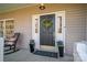Charming front door adorned with a wreath, potted flowers, and sidelights enhances curb appeal at 107 Doris Ct, Lincolnton, NC 28092