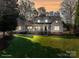 Charming two-story home featuring a welcoming front porch and lush, green lawn at dusk at 107 Doris Ct, Lincolnton, NC 28092