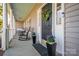 Inviting front porch adorned with rocking chairs, potted plants, and a festive wreath on the front door at 107 Doris Ct, Lincolnton, NC 28092