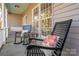 Relaxing front porch with rocking chairs, floral cushions and a swing; perfect for enjoying the outdoors at 107 Doris Ct, Lincolnton, NC 28092