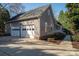 Spacious two-car garage with panel doors, complimented by an extended driveway and meticulous landscaping at 107 Doris Ct, Lincolnton, NC 28092