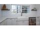 Bright kitchen features a farmhouse sink, subway tile backsplash, and abundant natural light from the large window at 107 Doris Ct, Lincolnton, NC 28092