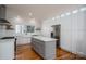 Modern kitchen with stainless steel appliances, white cabinets, and a gray center island with drawers at 107 Doris Ct, Lincolnton, NC 28092