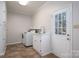 Functional laundry room with tile flooring, a sink, a washer, a dryer, and storage cabinets at 107 Doris Ct, Lincolnton, NC 28092