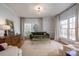 Serene living room with large windows, hardwood floors, and a comfortable seating arrangement at 107 Doris Ct, Lincolnton, NC 28092