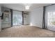 Spacious main bedroom with neutral decor, large windows, access to a back yard, and ample closet space at 107 Doris Ct, Lincolnton, NC 28092