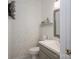 Stylish powder room features elegant wallpaper, a modern vanity, and decorative accents at 107 Doris Ct, Lincolnton, NC 28092