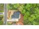 Aerial view of a brick home, featuring manicured landscaping, concrete driveway, and lush greenery at 109 Stirling Heights Ln, Fort Mill, SC 29715