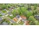Aerial view of a brick home featuring manicured landscaping, lush greenery, and a swimming pool nearby at 109 Stirling Heights Ln, Fort Mill, SC 29715