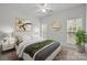 Serene bedroom with a ceiling fan, a comfortable bed, and natural light from the two windows at 109 Stirling Heights Ln, Fort Mill, SC 29715
