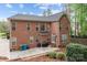 Exterior view of a well maintained brick home with a patio, backyard, and lush landscaping at 109 Stirling Heights Ln, Fort Mill, SC 29715