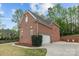 Exterior view of brick home featuring an attached garage, well-maintained lawn and concrete driveway at 109 Stirling Heights Ln, Fort Mill, SC 29715