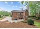 Exterior view of a well maintained brick home with a patio and landscaped backyard at 109 Stirling Heights Ln, Fort Mill, SC 29715