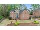 Charming two-story brick and stone home with well-manicured lawn and lush landscaping at 109 Stirling Heights Ln, Fort Mill, SC 29715