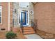 Close up of the front door with brick steps and iron railings at 109 Stirling Heights Ln, Fort Mill, SC 29715
