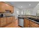 Kitchen with wooden cabinets, stainless steel appliances, and hardwood floors, offering a blend of style and functionality at 109 Stirling Heights Ln, Fort Mill, SC 29715