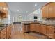 Kitchen with a view into an adjacent living area with a vaulted ceiling and many windows at 109 Stirling Heights Ln, Fort Mill, SC 29715