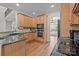 Kitchen with wooden cabinets, stainless steel appliances, and a view into the adjacent dining room at 109 Stirling Heights Ln, Fort Mill, SC 29715