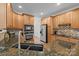Kitchen with granite countertops, stainless steel appliances, and wooden cabinets providing ample storage at 109 Stirling Heights Ln, Fort Mill, SC 29715