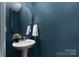 Chic half-bathroom features stylish vanity and eye-catching navy blue walls at 1178 Valley St, Statesville, NC 28677
