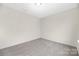 Carpeted bedroom featuring neutral colors and a minimalist aesthetic at 1178 Valley St, Statesville, NC 28677