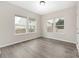 Well-lit bedroom featuring wood-look floors and large windows overlooking the fenced backyard at 1178 Valley St, Statesville, NC 28677