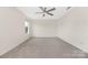 Spacious bedroom featuring a ceiling fan, neutral walls, carpet floors, and a large window for plenty of natural light at 1178 Valley St, Statesville, NC 28677