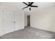 Carpeted bedroom with a modern ceiling fan and closet at 1178 Valley St, Statesville, NC 28677