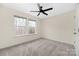 Well-lit bedroom features a modern ceiling fan and two bright windows at 1178 Valley St, Statesville, NC 28677