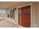 Inviting front entry with a stylish dark-stained door and covered porch at 1178 Valley St, Statesville, NC 28677