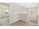 Bright hallway with neutral tones, carpet flooring and a view of another room through a doorway at 1178 Valley St, Statesville, NC 28677