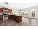 Modern kitchen with stainless appliances, wood cabinets, granite countertops, and wood-look flooring at 1178 Valley St, Statesville, NC 28677