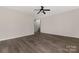 Open-concept living room with ceiling fan and wood-look flooring, showing staircase in the background at 1178 Valley St, Statesville, NC 28677