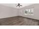 Bright living room featuring wood-look flooring, ceiling fan, and natural light from double-hung windows at 1178 Valley St, Statesville, NC 28677