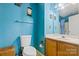 Blue bathroom featuring a single sink vanity, toilet, and shower/tub combo at 11834 Mallard Ridge Dr, Charlotte, NC 28269