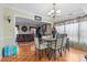 Bright dining area featuring hardwood floors, stylish lighting fixture and view into the living room at 11834 Mallard Ridge Dr, Charlotte, NC 28269