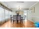Charming dining room featuring hardwood floors, crown molding and a decorative lighting fixture at 11834 Mallard Ridge Dr, Charlotte, NC 28269