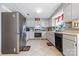 Well-lit kitchen with stainless steel appliances, ample counter space, and tile floors at 11834 Mallard Ridge Dr, Charlotte, NC 28269