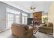 Inviting living room with a brick fireplace and natural light from the large windows and doors at 11834 Mallard Ridge Dr, Charlotte, NC 28269
