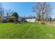 Spacious backyard with a fire pit area and lush lawn at 1310 Seneca Pl, Charlotte, NC 28209