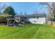 Spacious backyard with a fire pit area and lush lawn at 1310 Seneca Pl, Charlotte, NC 28209