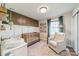 Charming Bedroom features a wooden crib, accent wall, a plush chair, and ample natural light at 1310 Seneca Pl, Charlotte, NC 28209