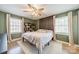 Comfortable bedroom with a ceiling fan, large windows, and an accent wall, providing a serene retreat at 1310 Seneca Pl, Charlotte, NC 28209