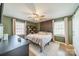Cozy bedroom with a ceiling fan, two windows, and an accent wall for a warm and inviting space at 1310 Seneca Pl, Charlotte, NC 28209