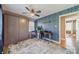 Home office space with a Murphy bed, a ceiling fan, and bright wall, for a stylish and functional room at 1310 Seneca Pl, Charlotte, NC 28209