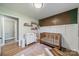Bright Bedroom features an accent wall, wooden crib, changing table, and stylish decor at 1310 Seneca Pl, Charlotte, NC 28209