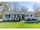 Charming one-story home features a well-manicured front yard and classic brick exterior at 1310 Seneca Pl, Charlotte, NC 28209