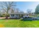 Charming home featuring a well-manicured front yard and mature trees at 1310 Seneca Pl, Charlotte, NC 28209