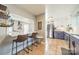 Charming kitchen with breakfast bar, stainless steel appliances, and stylish white and purple cabinets at 1310 Seneca Pl, Charlotte, NC 28209